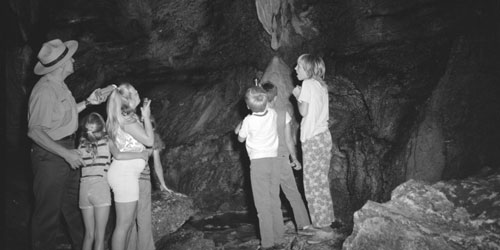 Park ranger and children in Gregory cave circa 1973