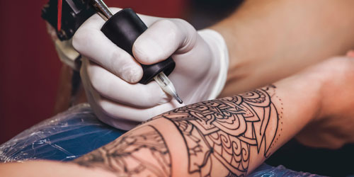 Tattoo artist with needle Tattoo artist with needle