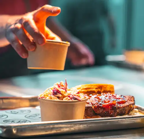Chef serving Trotter's BBQ